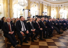 Grupa mężczyzn siedzących na sali