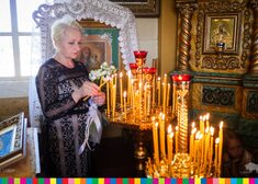 Wiesława Burnos zapala świeczki w cerkwi