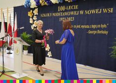 Wiesława Burnos przekazuje dyrektorce kwiaty