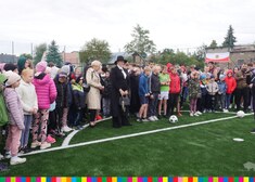 Tłum ludzi stojący przed polem karnym na boisku piłkarskim