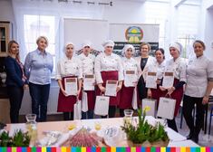 Wiesława Burnos i kucharki stoją w rzędzie z dyplomami