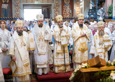 Duchowni stoją w rzędzie przed ołtarzem, za nimi wierni 