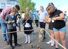 Dzieci trzymają kije ze sznurkiem udające wędki